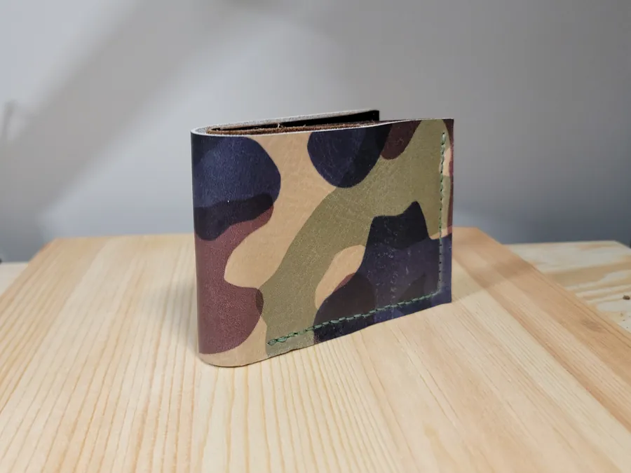 Bifold wallet in woodland camo leather with green stitching