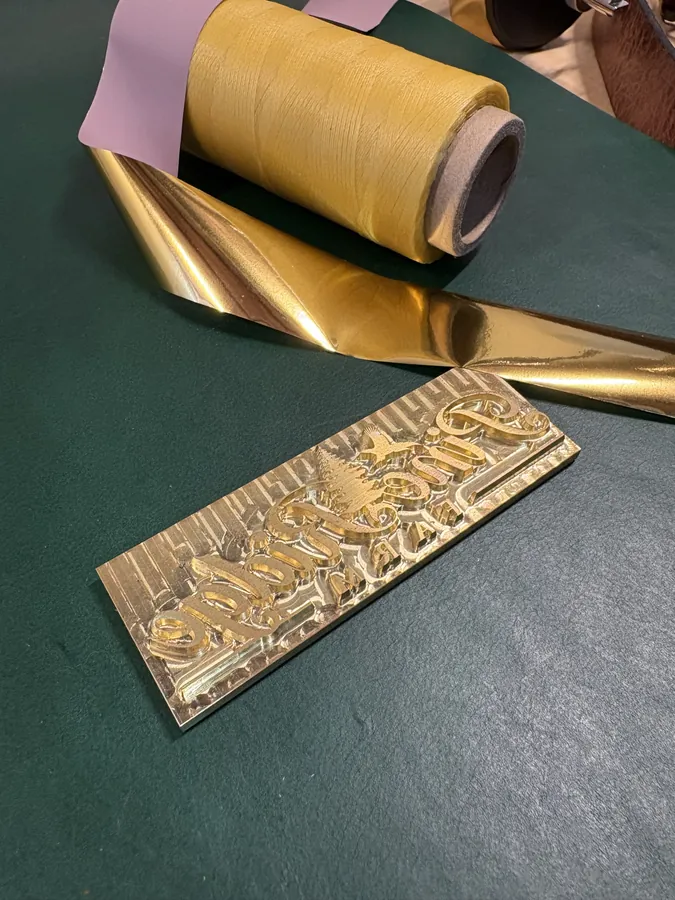 Gold hot-foil rolls and our custom stamping die on the cutting mat