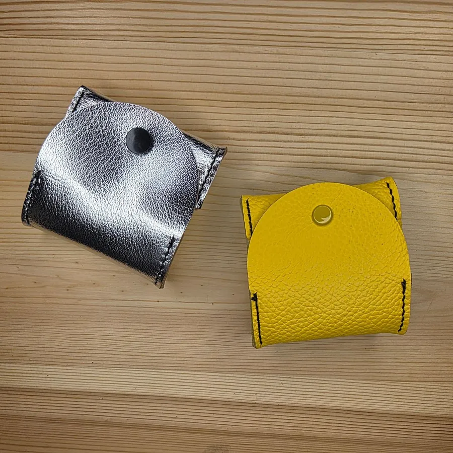 Two snap coin purses in metallic silver and yellow pebbled leather